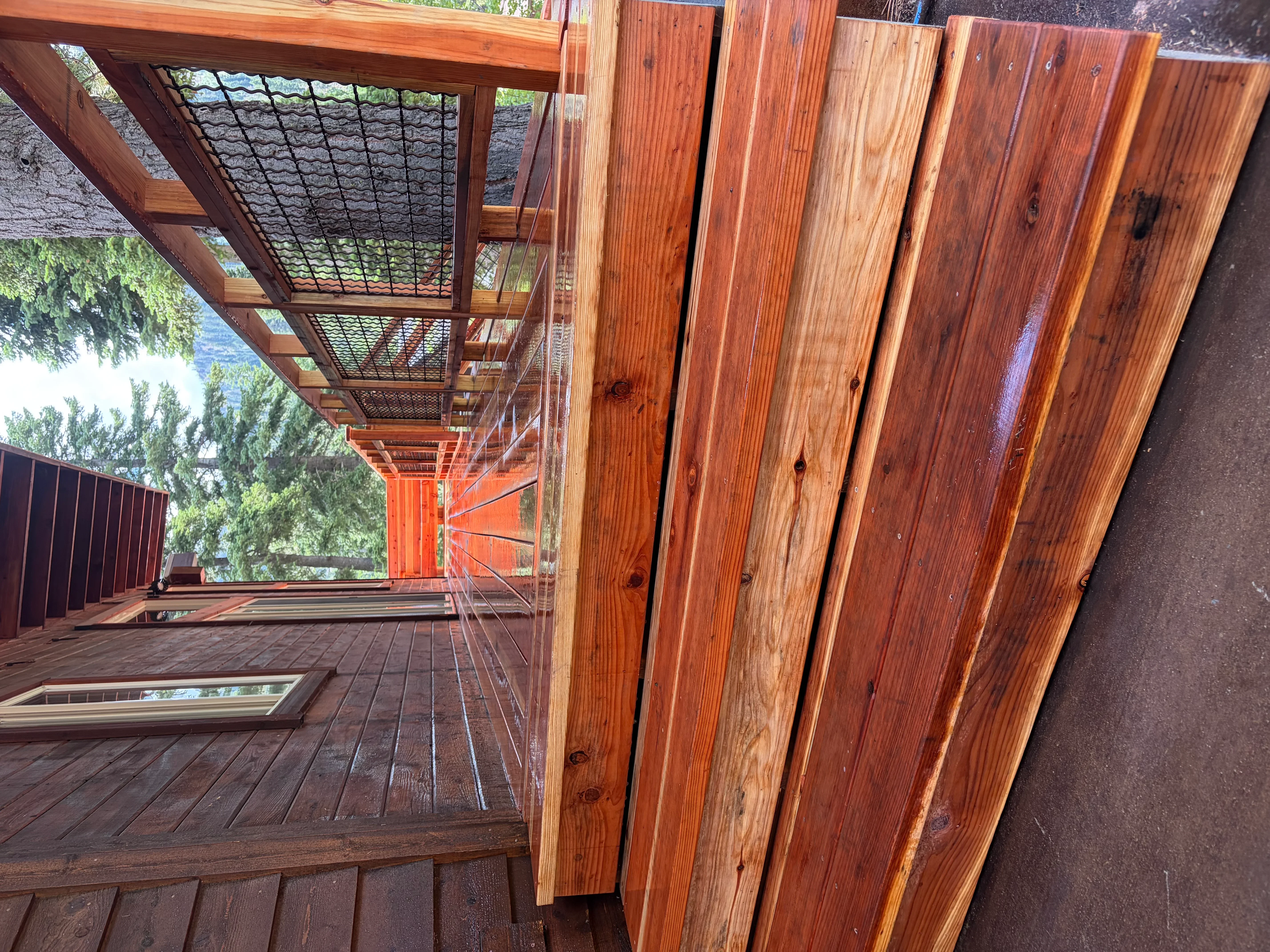 Cedar deck with pergola, cable railing, and stained wood decking