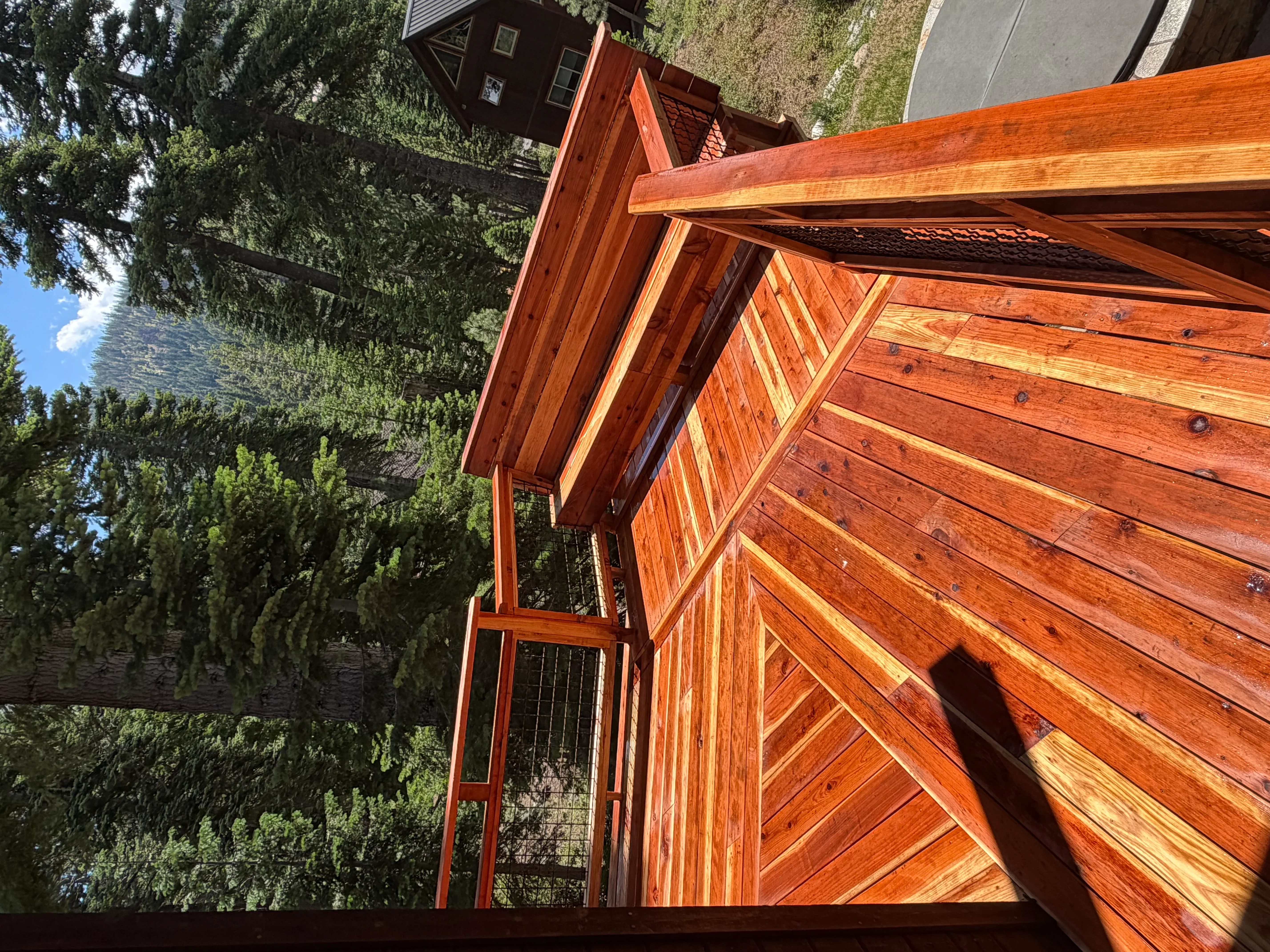Cedar deck with diagonal pattern boards and attached pergola shade structure with lattice panels