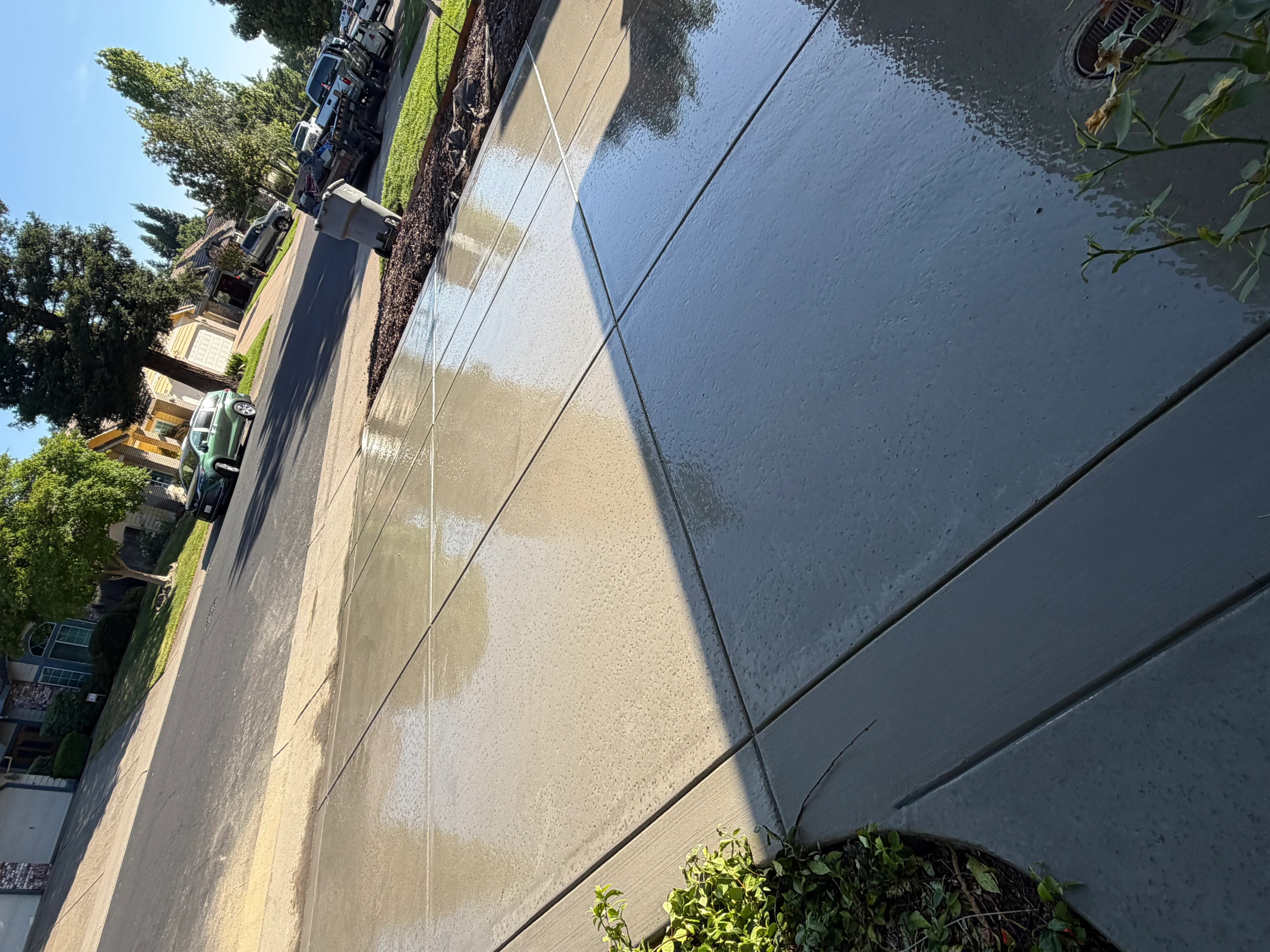 Concrete driveway after pressure washing and sealing treatment